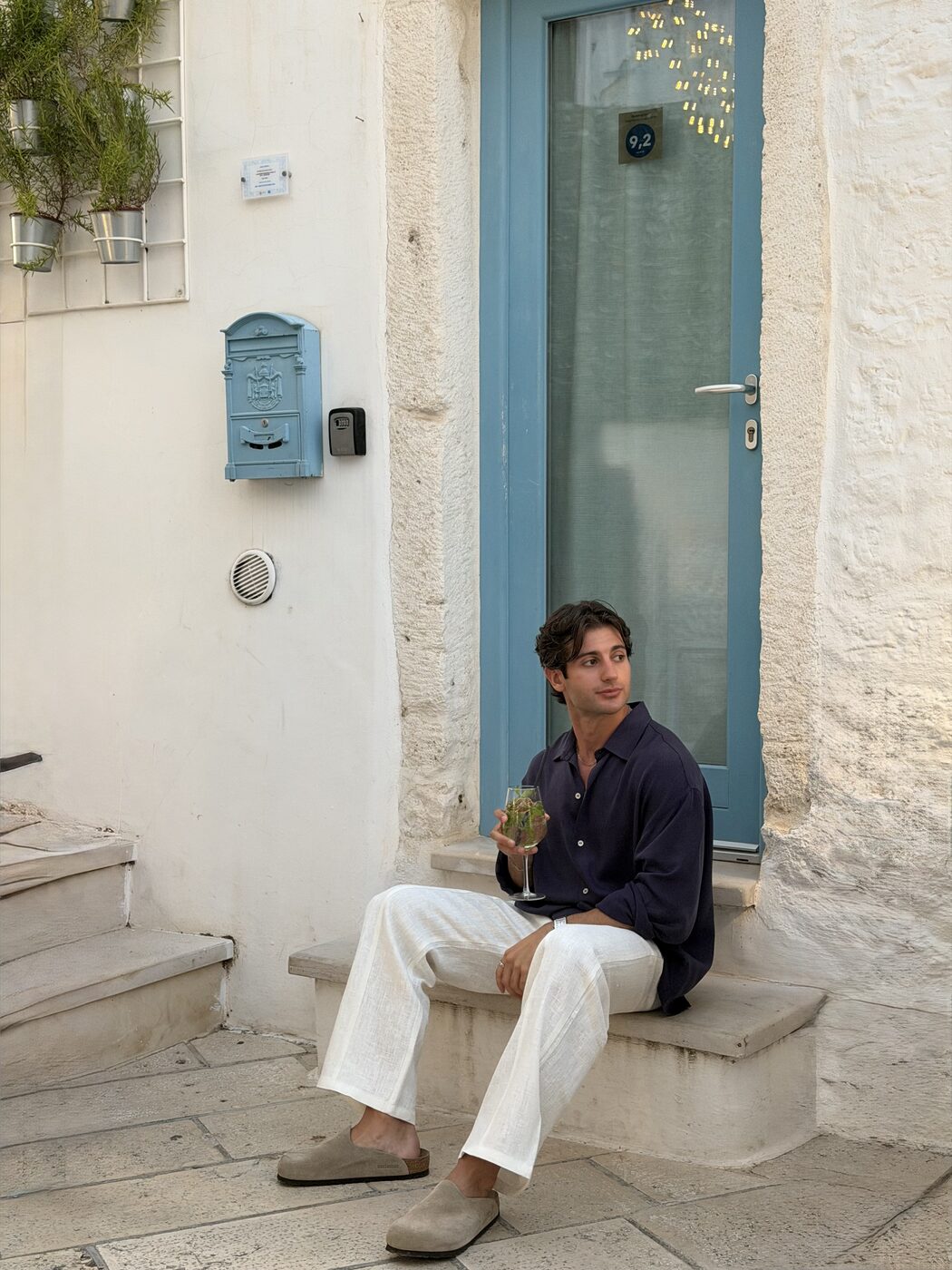 Gio Mineo — seated, blue doorway