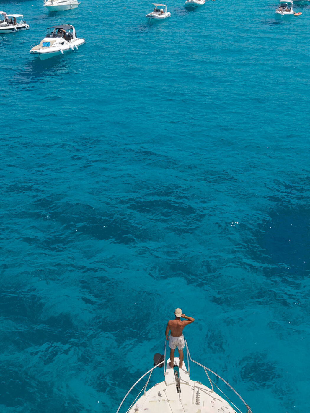 Gio Mineo — drone shot, boat bow in turquoise water